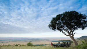 maasai-man-overlooking-vast-plains-of-the-masai-mara